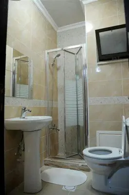 a bathroom with a shower and a toilet and a sink at سامر برهم للاسكان in Amman