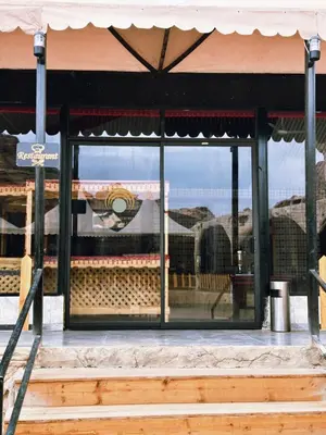 a store front window with a reflection of a building at Laurana Rum Luxury Camp in Wadi Rum
