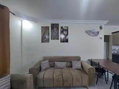 a living room with a couch and a table at New zarqa in Az Zarqa