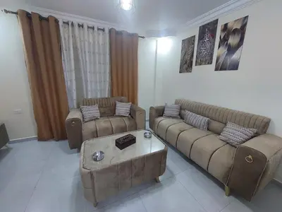 a living room with two couches and a coffee table at New zarqa in Az Zarqa