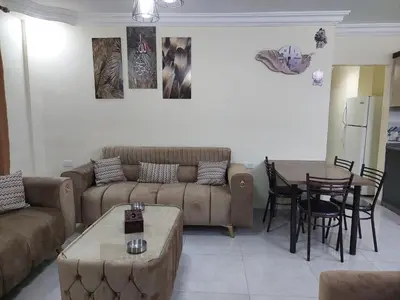 a living room with a couch and a table at New zarqa in Az Zarqa