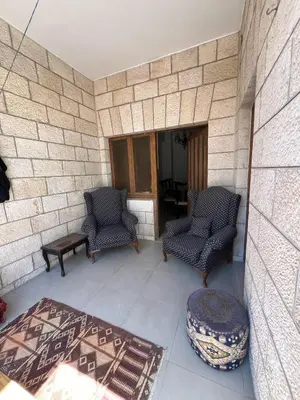 two chairs and a ottoman on a patio at Locations Amman Palm Tree 4 in Ash Shumaysānī