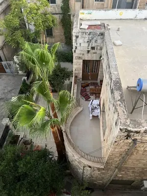 an overhead view of a building with a palm tree at Locations Amman Palm Tree 4 in Ash Shumaysānī