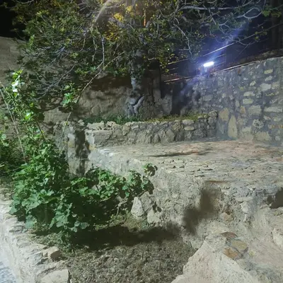 a stone wall at night with a light at Dana Moon hostel in Dana