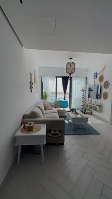 a living room with a couch and a table at Azure haven Ayla Sea view Apartment in Aqaba
