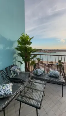 three benches on a balcony with a view of the ocean at Azure haven Ayla Sea view Apartment in Aqaba