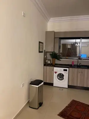 a kitchen with a washing machine and a microwave at Family Spacious newly furnished 2 Bedroom 2 bath in Amman