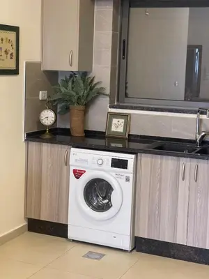a washing machine in a kitchen with a counter at Family Spacious newly furnished 2 Bedroom 2 bath in Amman