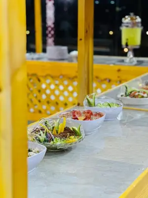 a table topped with bowls of food on a table at Wadi Rum famous luxury camp in Wadi Rum