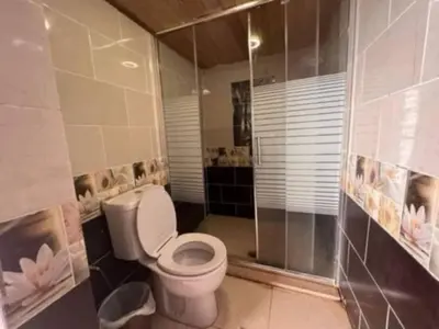 a bathroom with a toilet and a shower at Sami Rum Mountains in Wadi Rum