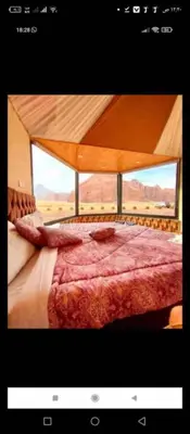 a bedroom with a bed with a view of the desert at Sami Rum Mountains in Wadi Rum