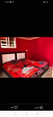 a red bedroom with a bed with a red wall at Sami Rum Mountains in Wadi Rum