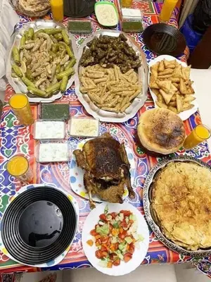 a table with plates of food on a table at Daban Inn in Dhībān