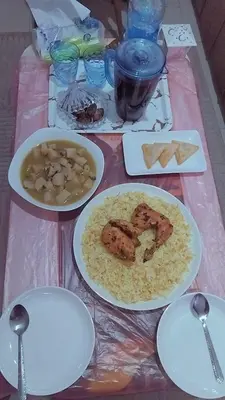 a table with plates of food on a table at Daban Inn in Dhībān