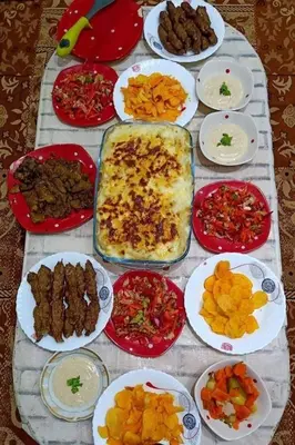 a table with many plates of food on it at Daban Inn in Dhībān