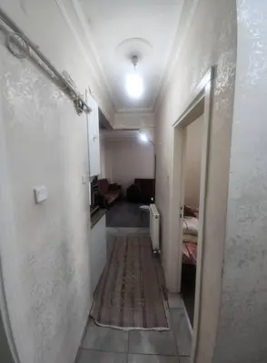 a hallway leading to a room with a bedroom at Daban Inn in Dhībān