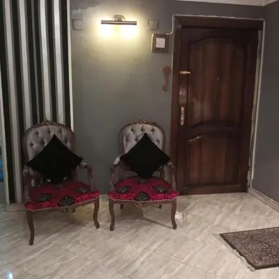 two chairs with pillows sitting next to a door at Noplity bed and breakfast in Al Qunayţirah