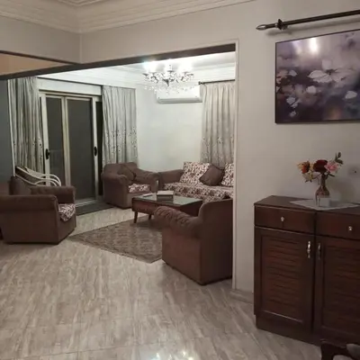 a living room with couches and a chandelier at Noplity bed and breakfast in Al Qunayţirah