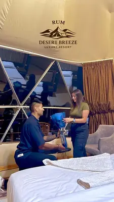 a man and a woman standing in a room with beds at RUM DESERT BREEZE lUXURY CAMP&JEEP TOUR in Wadi Rum