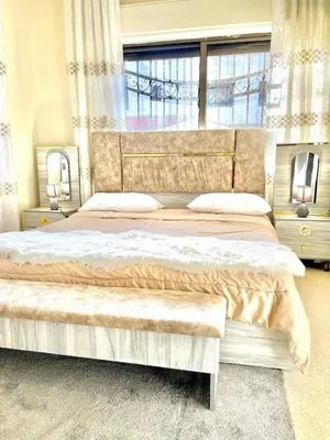 a bedroom with two beds and a large window at Stylish 3 Bedroom apartment in Amman in Amman