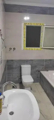 a bathroom with a toilet and a sink and a tub at بيت راس هوستل in Bayt Raʼs