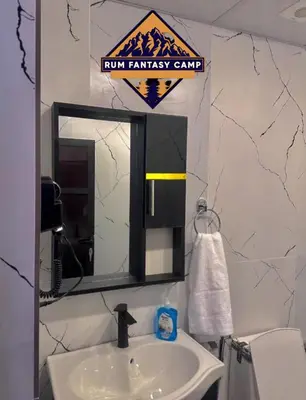 a bathroom with a sink and a mirror at RUM FANTAS BUBBLE lUXURY CAMP in Wadi Rum