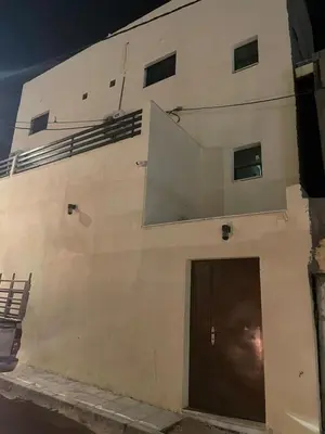 a white building with a door on the side of it at Old town apartment 2 in Aqaba