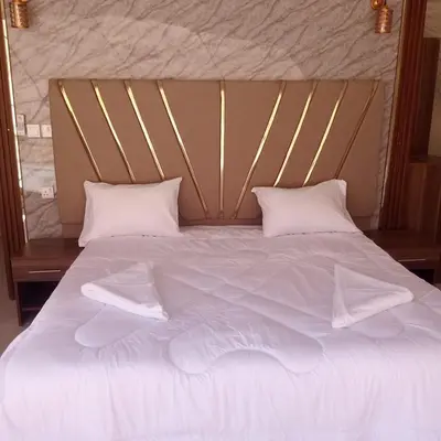 a large bed with white sheets and pillows at Lowrance luxury camp in Wadi Rum