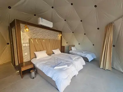 a bedroom with two beds in a tent at Lowrance luxury camp in Wadi Rum