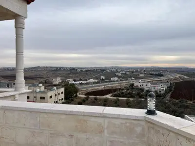 a view of a city from the balcony of a building at شقه مفروشة ذات اطلالة جميلة ومكان هادئ in Irbid