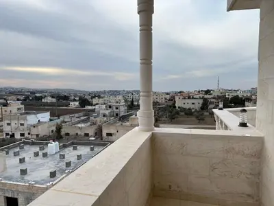 a view of the city from the balcony of a building at شقه مفروشة ذات اطلالة جميلة ومكان هادئ in Irbid