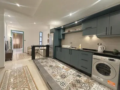 a kitchen with a washer and a washing machine at Old Town Charming Two-Bedroom Flat in Amman