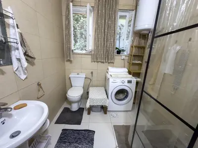 a bathroom with a toilet and a washing machine at 2 Bedroom apt in Jabal Weibdeh with Balcony in Amman