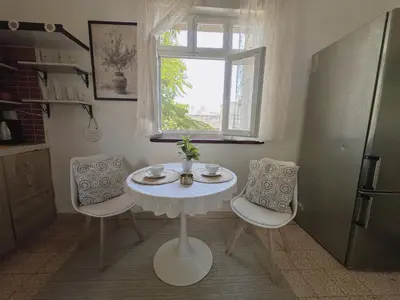 a table and chairs in a kitchen with a window at 2 Bedroom apt in Jabal Weibdeh with Balcony in Amman
