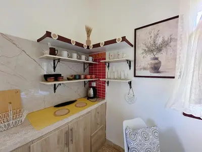 a kitchen with a counter and shelves in a room at 2 Bedroom apt in Jabal Weibdeh with Balcony in Amman