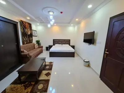 a living room with a bed and a couch at ساكب هاوس in Sākib