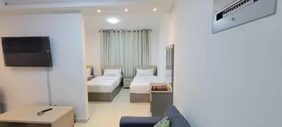 a hotel room with two beds and a tv at مراسيم للشقق الفندقية in Amman