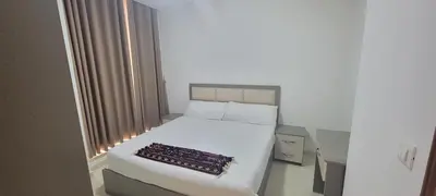 a white bed in a room with a window at مراسيم للشقق الفندقية in Amman