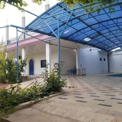 a large building with a blue glass roof at سموع فارم in Sammū‘