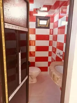 a bathroom with a toilet and a sink at سموع فارم in Sammū‘