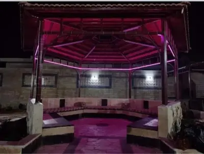 an empty stage with pink lighting in a building at سموع فارم in Sammū‘