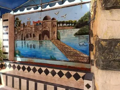 a mural on the side of a building at سموع فارم in Sammū‘