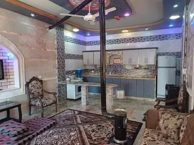 a large kitchen with a couch and a table in a room at سموع فارم in Sammū‘