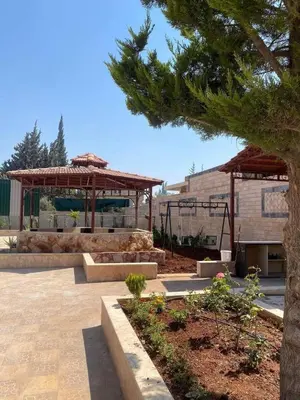 a park with a gazebo and a building at سموع فارم in Sammū‘