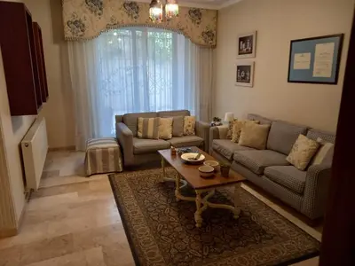 a living room with a couch and a table at Happy Family Home with Spacious Garden in Amman