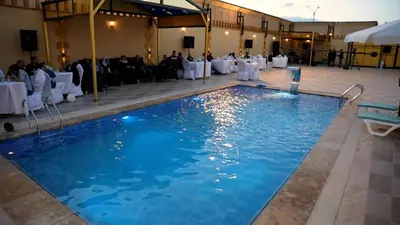 a swimming pool with a table set up for a party at Kareem celebrations Hall صاله افراح in Irbid