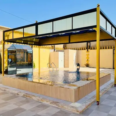 a swimming pool in a building with a yellow building at Kareem celebrations Hall صاله افراح in Irbid