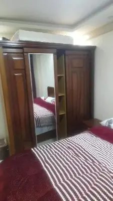 a bedroom with a bed and a mirror next to a bed at الجفر موتل in Al Jafr