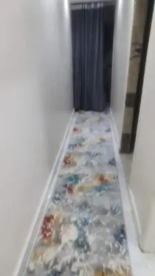 a hallway with a flower patterned carpet on the floor at الجفر موتل in Al Jafr