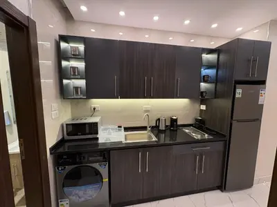 a kitchen with a sink and a dishwasher at Third circle Luxury Hotel apartment New in Amman